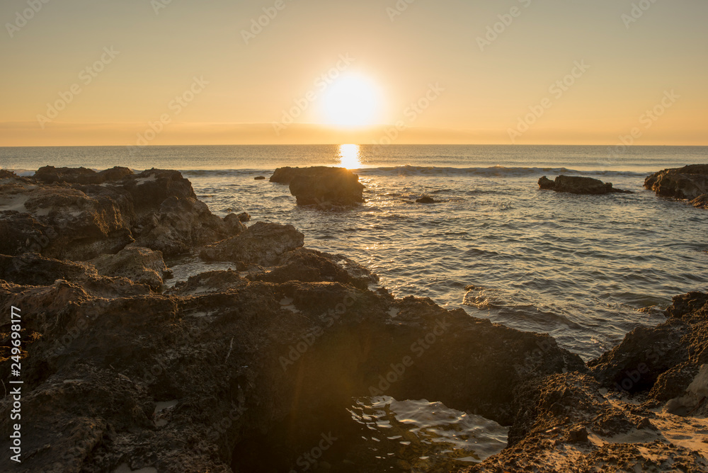 Fototapeta premium A sunrise between the rocks of Oropesa del Mar