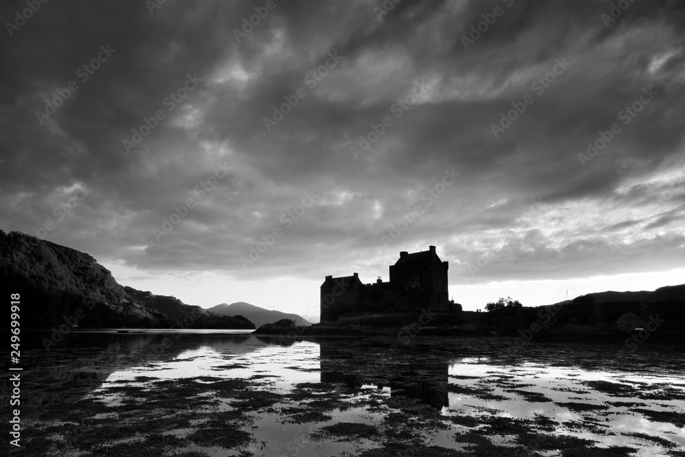 Eilean Donan Castle during blue hour after sunset. Reflecting itself into the water during evening, Loch Duich, Dornie, Scotland, UK. Awesome seascape Most popular place Beautiful landscape background