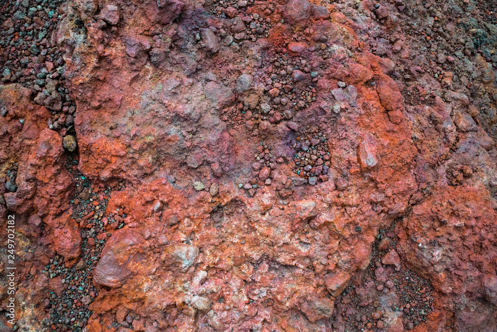 Nature abstract brown lava stone background featuring details of volcanic stones at slope of Etna volcano, Sicilia, Italy. Various colors are attributed to various minerals in lava. Nature abstract brown lava stone background featuring details of volcanic stones at slope of Etna volcano, Sicilia, Italy. Various colors are attributed to various minerals in lava.