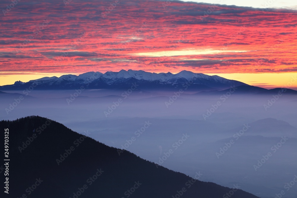Panoramic view of beautiful winter wonderland mountain scenery in evening light at sunset. Carpathian mountains above the clouds. Christmas and New year. Panoramic view of beautiful winter wonderland mountain scenery in evening light at sunset. Carpathian mountains above the clouds. Christmas and New year.