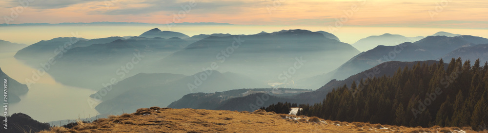 Great landscape at Iseo lake in winter season, foggy an humidity in the air. Panorama from Monte Pora, Alps, Italy