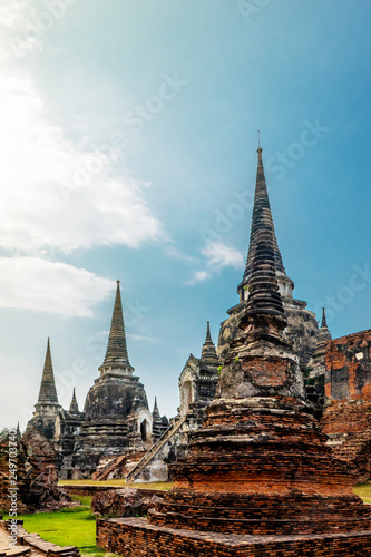 A three pagodas ruin public temple in Ayuthaya old city with white cloud and blue sky in Thailand.