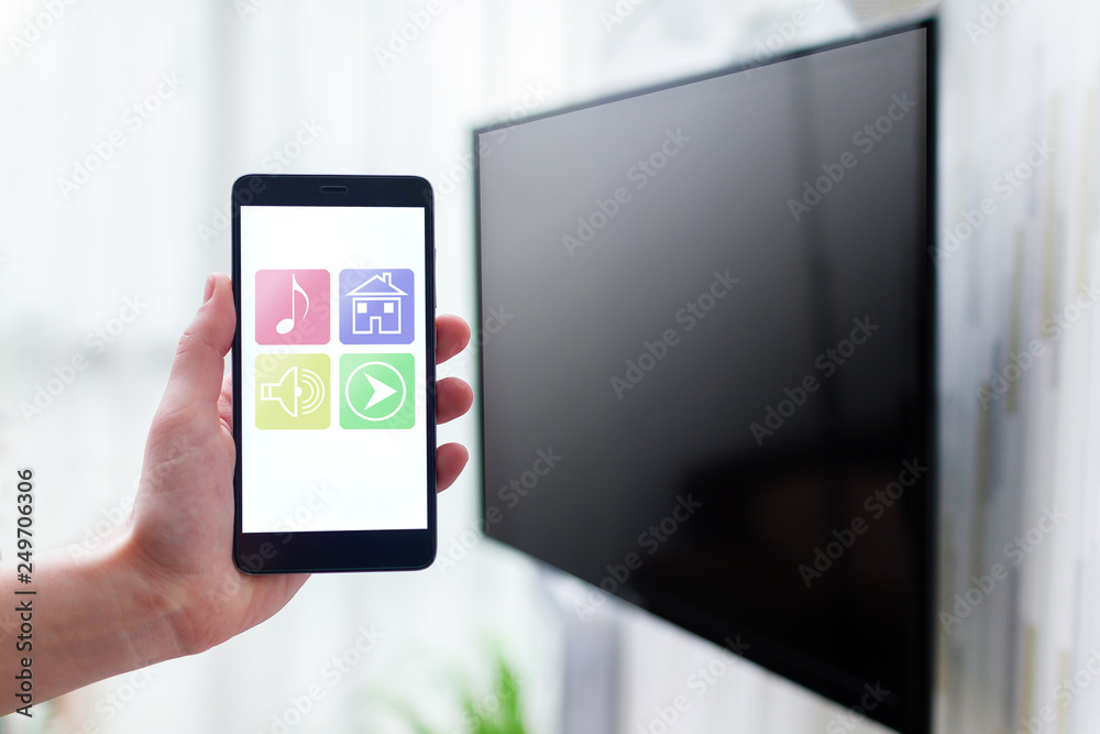 Online control smart TV by wifi using a mobile app on smartphone. Smart home