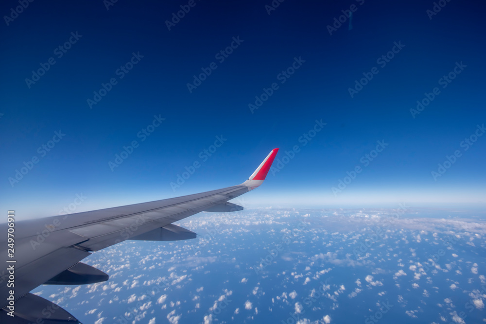 Fototapeta premium Aeroplane wing view from window beautiful sky. Traveling concept