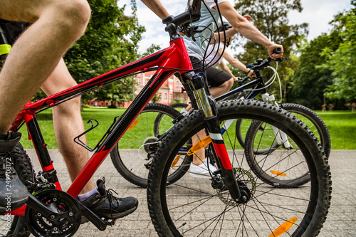 Healthy lifestyle - people riding bicycles in city park