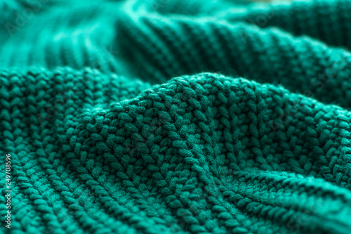 Knitted green background close up.