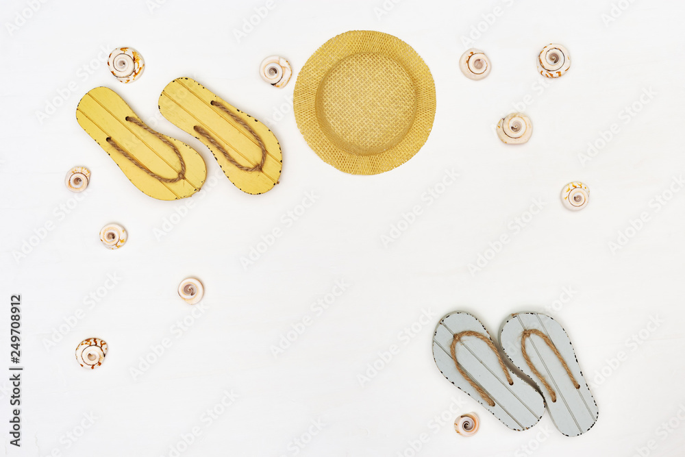 Fototapeta premium Beach flip flops and straw hat. Summer items on white background. Summer concept. Copy space.