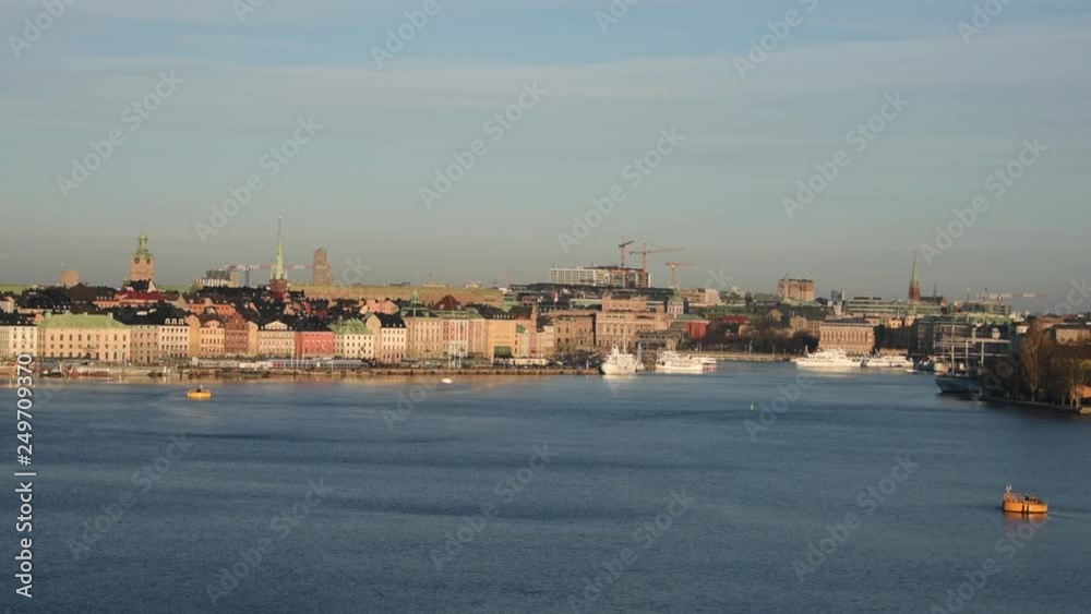 An sunny early spring day in Stockholm, view over a pier with boats, ferry and birds An sunny early spring day in Stockholm, view over a pier with boats, ferry and birds