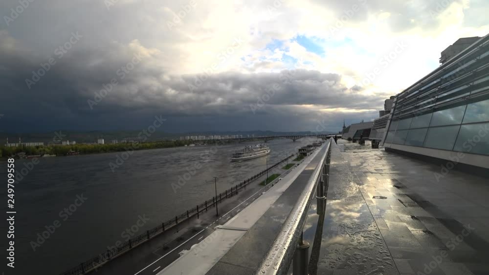 View from the embankment, in the distance the ship sails along the river, the bridge, the city, after the rain, clouds, metal View from the embankment, in the distance the ship sails along the river, the bridge, the city, after the rain, clouds, metal