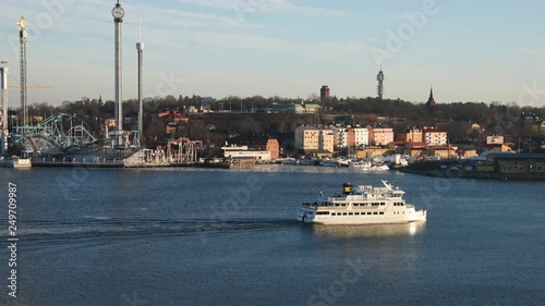 An sunny early spring day in Stockholm, view over a pier with boats, ferry and birds photo