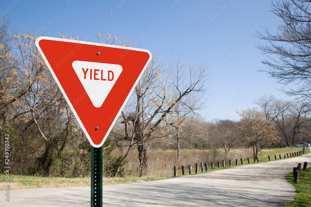 Yield Sign In A Park - obrazy, fototapety, plakaty 