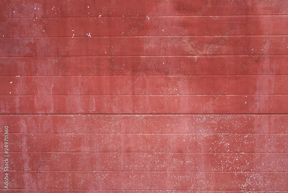 Fototapeta premium Texture of red peeling paint on the wall