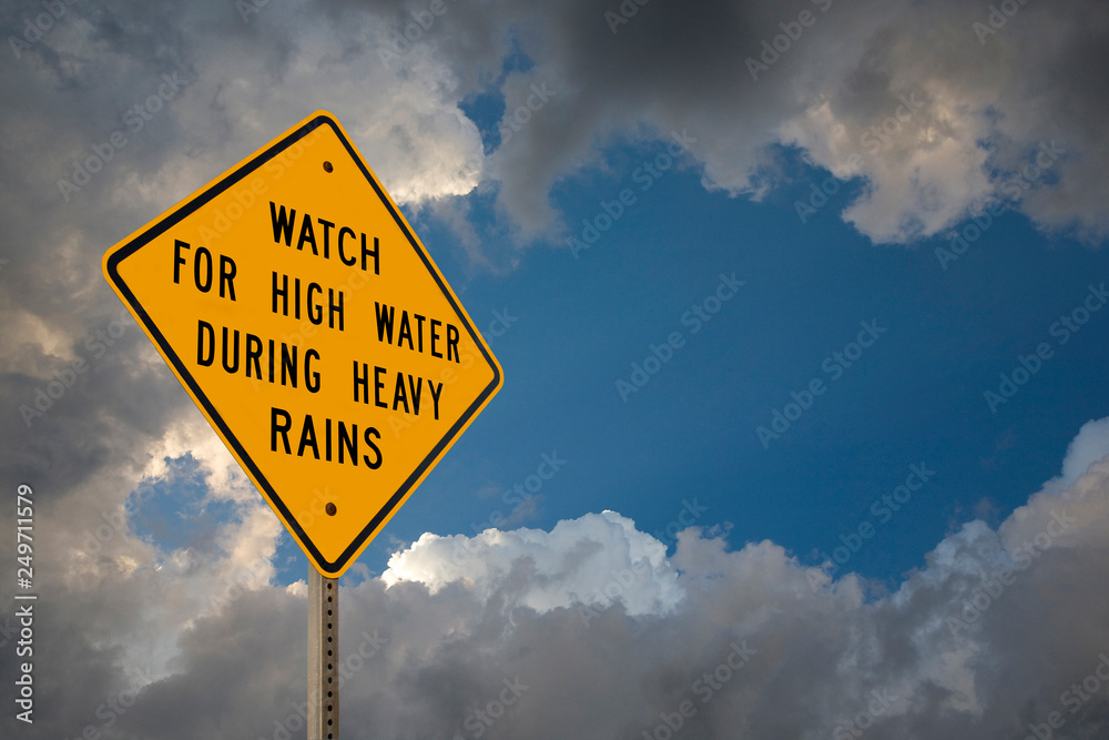 Watch For High Water Sign With Storm Clouds Watch For High Water Sign With Storm Clouds