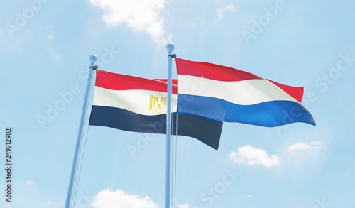 Netherlands and Egypt, two flags waving against blue sky. 3d image