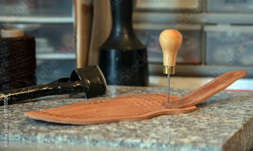Photos The leather crafter has her tools close at hand