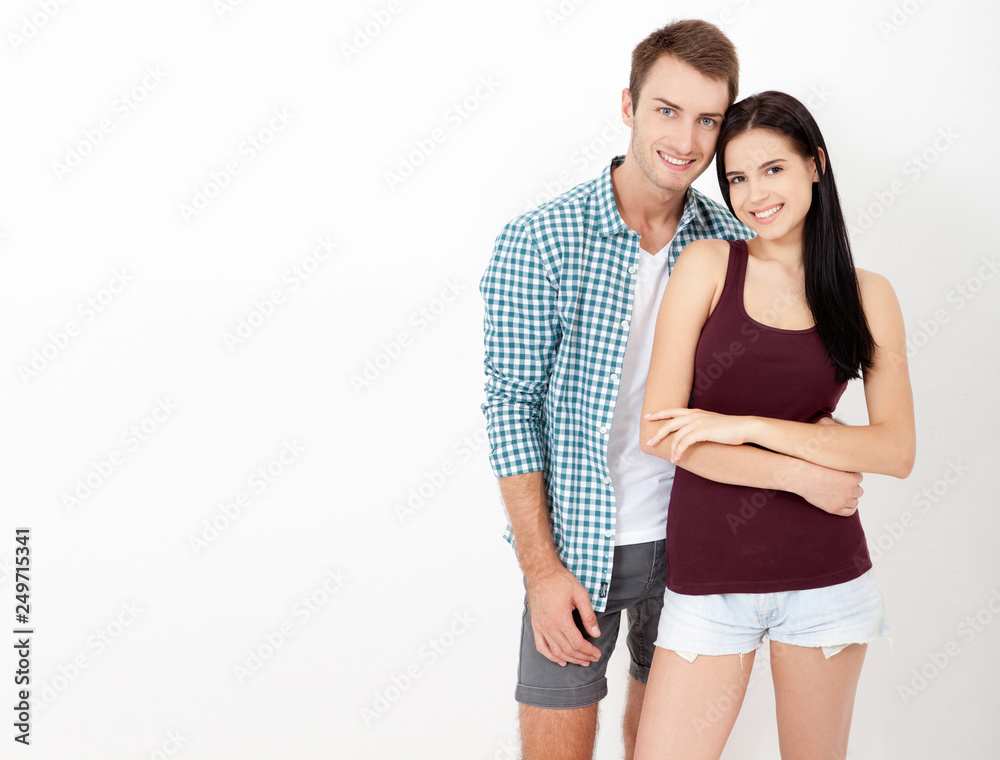 Happy couple embracing and looking camera on white background Happy couple embracing and looking camera on white background