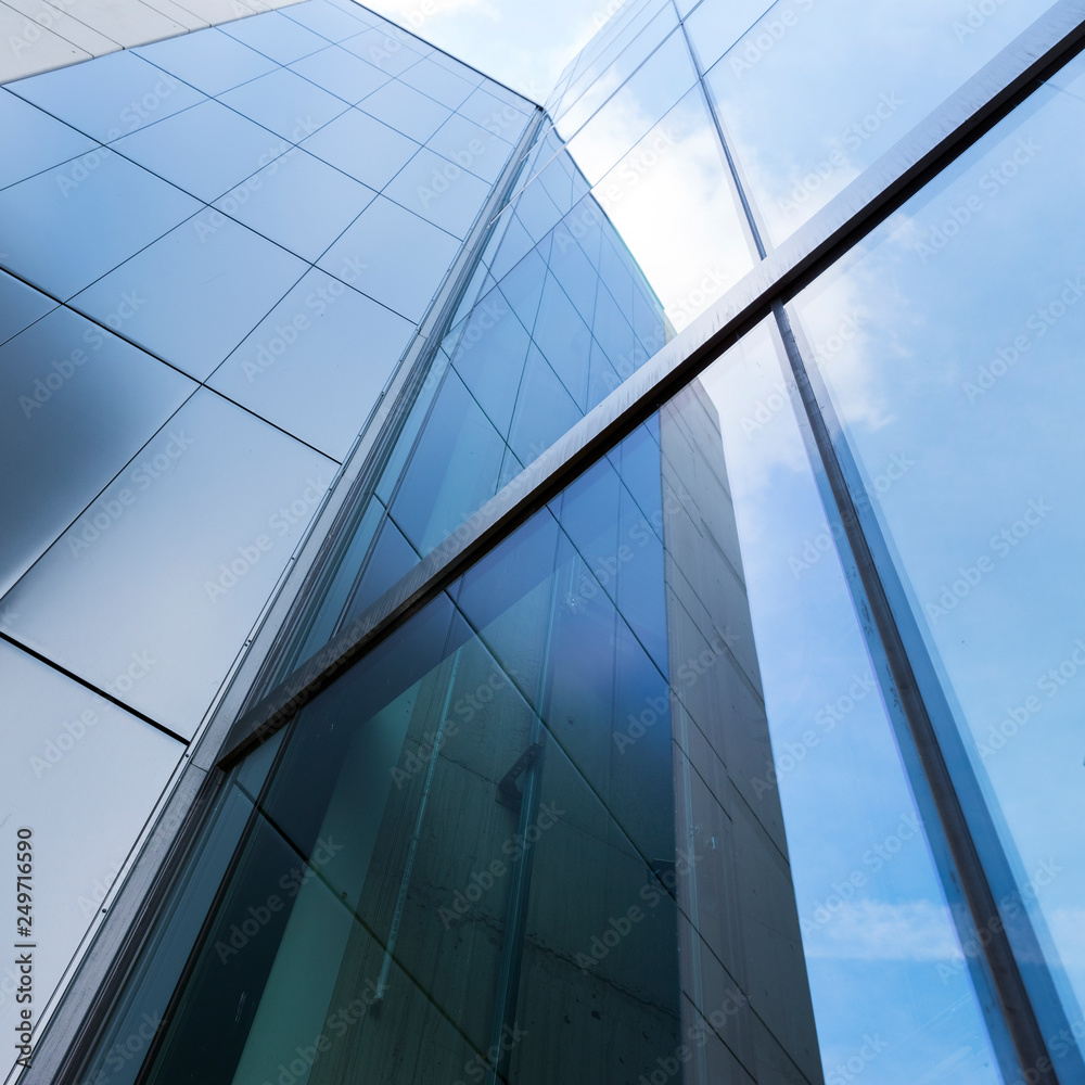 detail of modern office building with glass and steel reflecting blue sky detail of modern office building with glass and steel reflecting blue sky