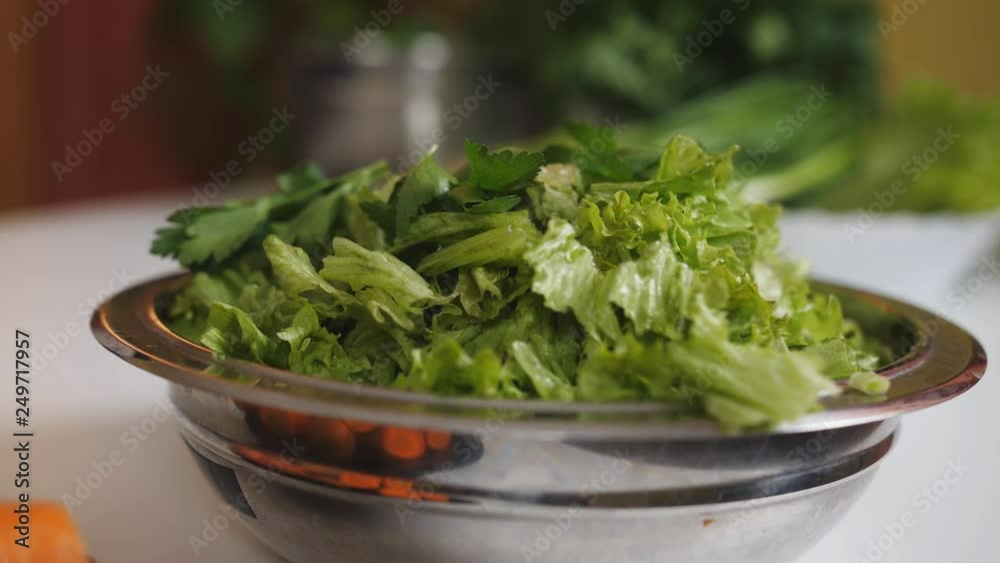 Closeup of a bowl with vegetable salad on the table in the kitchen. Closeup of a bowl with vegetable salad on the table in the kitchen.