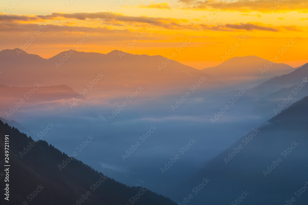 beautiful mountain valley in a blue mist at the early morning, natural background