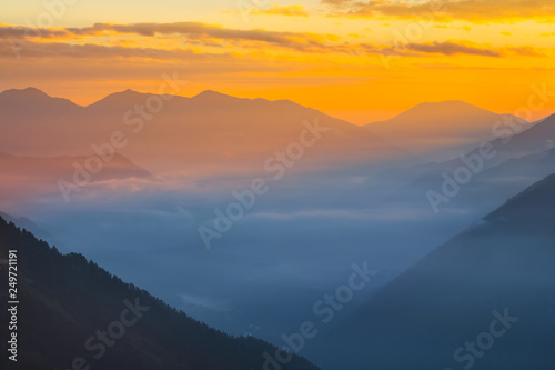 beautiful mountain valley in a blue mist at the early morning, natural background