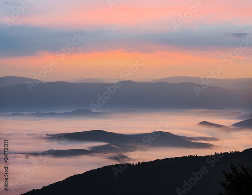quiet mountain valley in a blue mist at the dawn