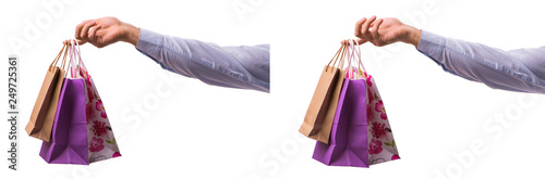 Hand holding shopping bags with christmas shopping on white back