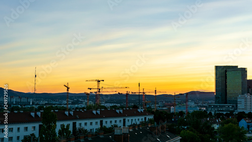 Sunset over Viennas Wienerberg area with office buildings and a construction site in the foreground