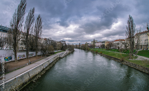 cityscape on the background of the river and clouds in the sky © Artem Orlyanskiy