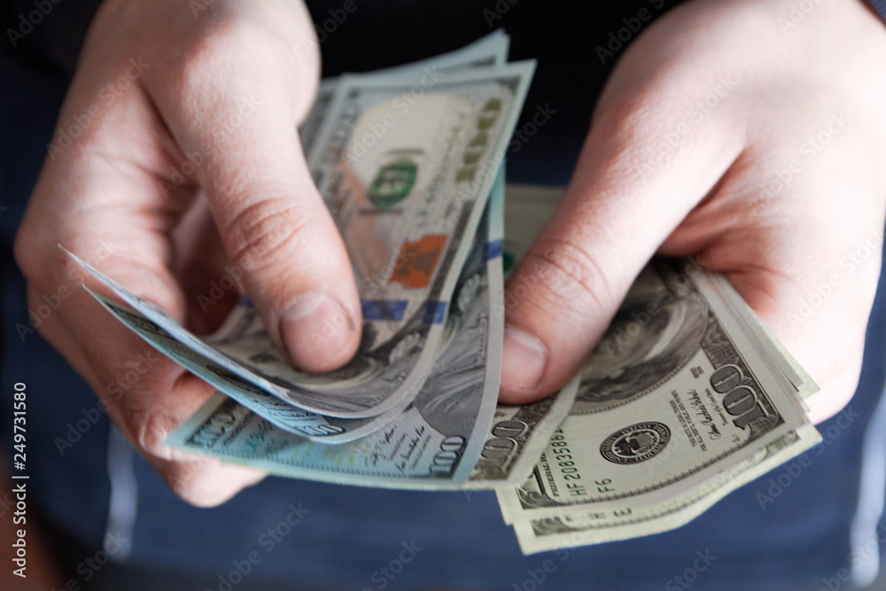 Man holdin money. Concept of savings, salary, payment and funds. Man counts cash bills.. Man holdin money. Concept of savings, salary, payment and funds. Man counts cash bills..