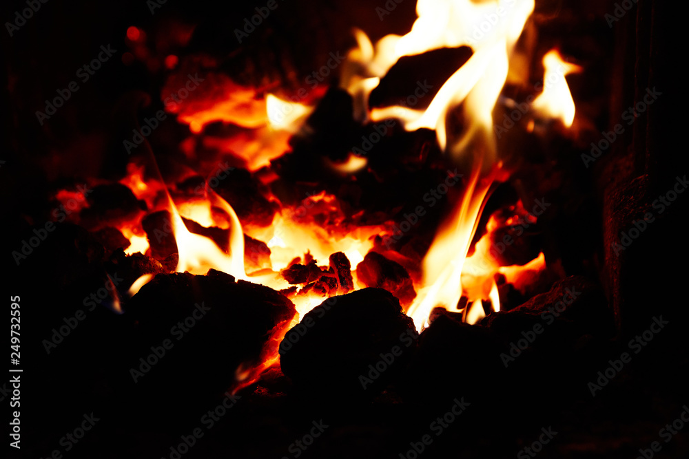 Burning and glowing pieces of wood in Fireplace