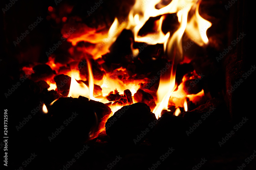 Burning and glowing pieces of wood in Fireplace Burning and glowing pieces of wood in Fireplace