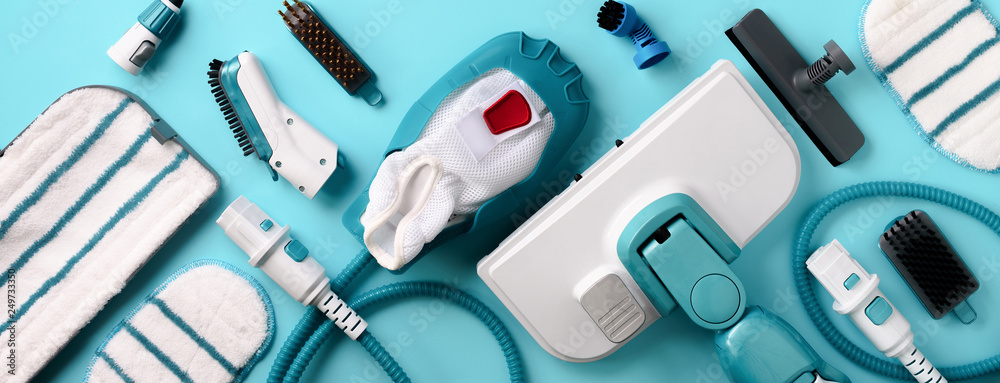 Fototapeta premium Set with modern professional steam cleaners on blue background. Top view, flat lay. Banner with copy space. Cleaning service concept