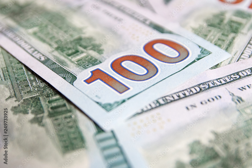 Fototapeta premium A pile of one hundred US banknotes with president portraits. Cash of hundred dollar bills, dollar background image with high resolution