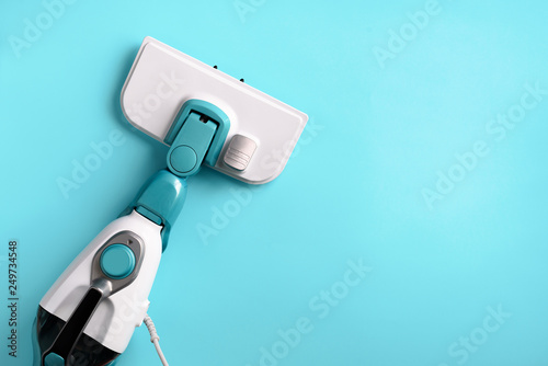 Steam cleaner mop on blue background. Top view, flat lay. Banner with copy space. Cleaning service concept