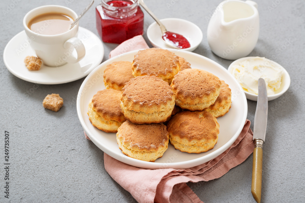 Traditional British Scones with clotted cream, strawberry jam and a cup of coffee. Traditional British Scones with clotted cream, strawberry jam and a cup of coffee.