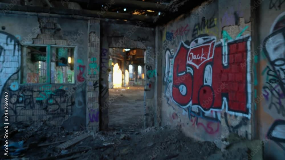 Old, abandoned and closed industrial factory building painted with graffiti