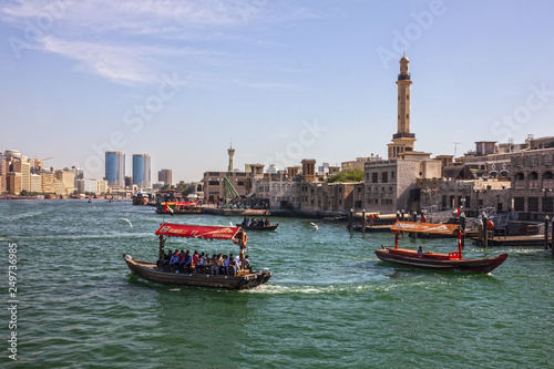 Dubai, UAE - Feb 15, 2019: Tourist boats abra on canal Dubai Creek and old town. photo