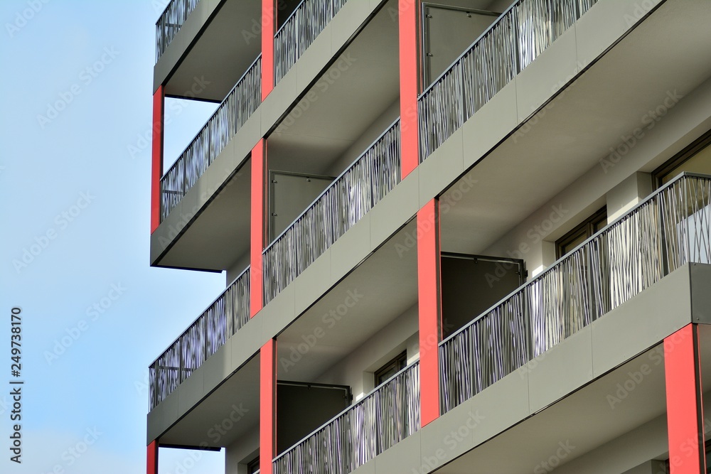 Fototapeta premium Modern apartment buildings on a sunny day with a blue sky. Facade of a modern apartment building