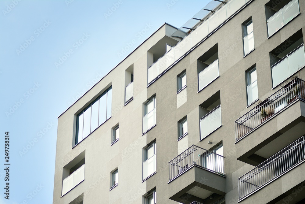 Modern apartment buildings on a sunny day with a blue sky. Facade of a modern apartment building Modern apartment buildings on a sunny day with a blue sky. Facade of a modern apartment building