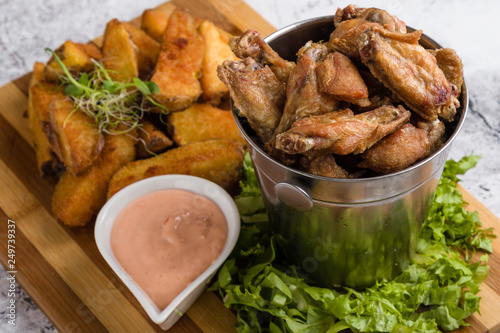 fried chicken wings with potato and dipping sauce