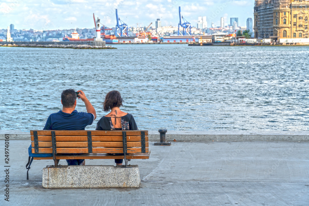 modern couple sitting at waterfront