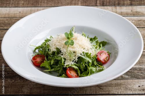fresh tasty healthy rucola salad in white plate
