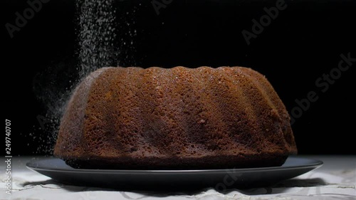 sprinkling with powdered sugar on a marble cake