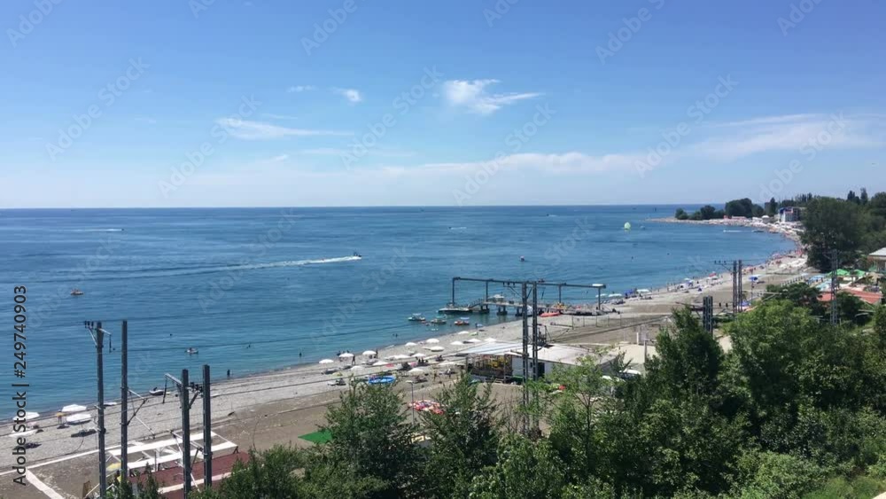 Pebble beach of the Lazarevskoe village. Rail road passing along sea shore. It is summer resort located in Sochi district, Krasnodar, Russia Pebble beach of the Lazarevskoe village. Rail road passing along sea shore. It is summer resort located in Sochi district, Krasnodar, Russia