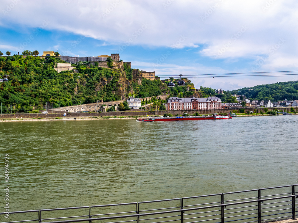 Obraz premium View of the Rhine River with a cargo ship, Phillipsburg Palace, Ehrenbreitstein Fortress and the aerial tramway