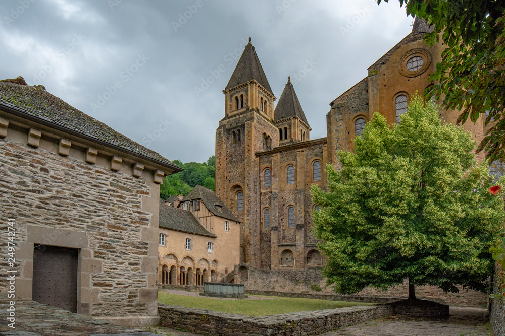 Fountain and arcade in the interior courtyard of the Conques monastery
