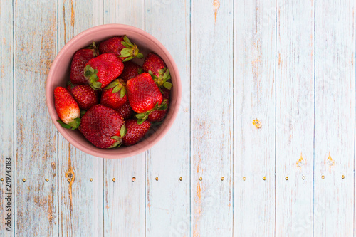 Sweet, juicy, ripe strawberries. Red, large strawberries in a pink cup. Food with vitamins. Vegetarian food. photo