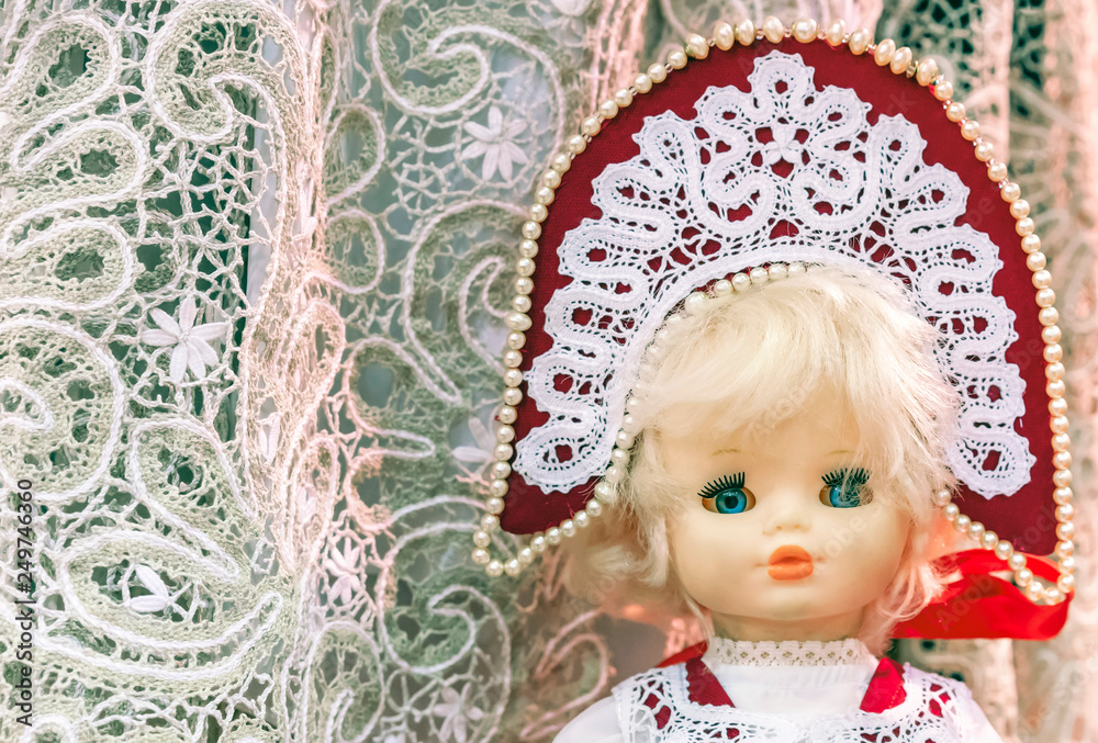 Doll in the national Russian costume on a lace background. Doll in the national Russian costume on a lace background.