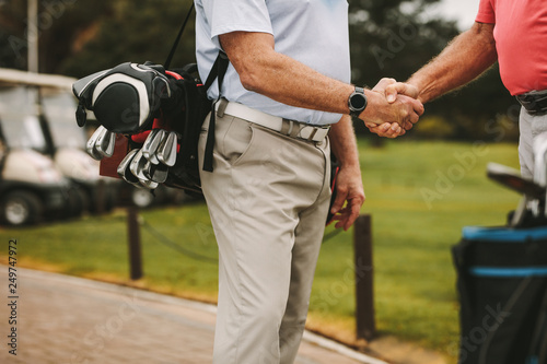 Golfers greeting each other with a handshake