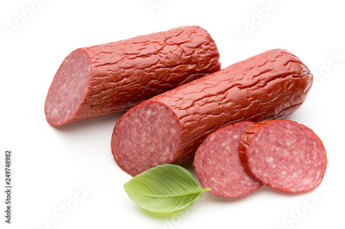 Salami smoked sausage, basil leaves on white background cutout.